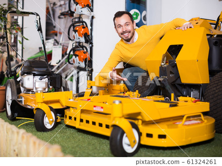 Man choosing lawnmower Man choosing lawnmower 61324261