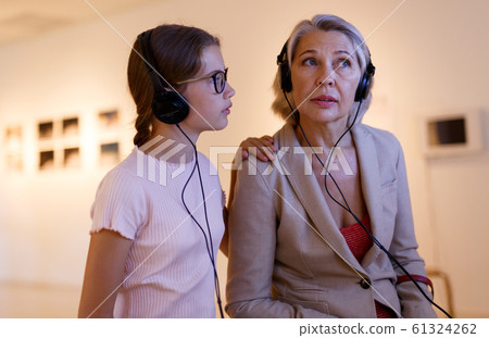 People using audio guide in museum People using audio guide in museum 61324262
