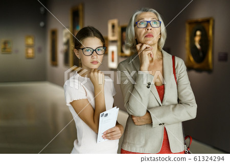 Woman and girl visiting museum Woman and girl visiting museum 61324294