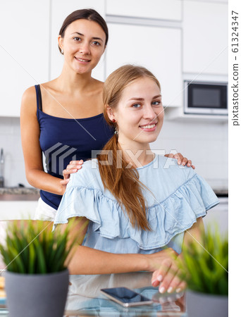 Portrait of young smiling girlfriends hugging and having fun together Portrait of young smiling girlfriends hugging and having fun together 61324347