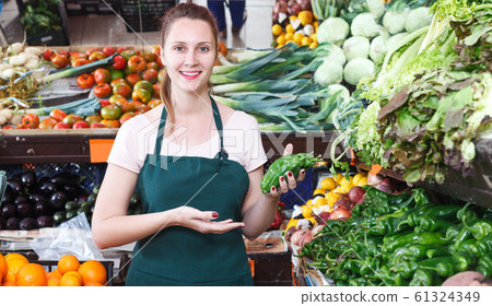 seller who is holding paprika in the market seller who is holding paprika in the market 61324349