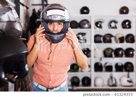 Man trying up moto helmet Man trying up moto helmet 61324353