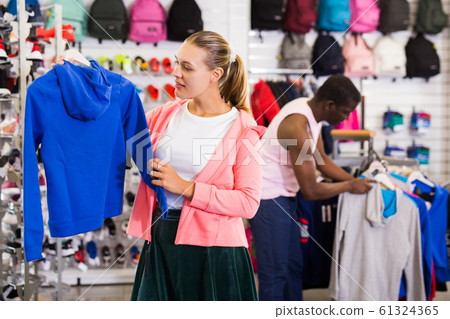 Woman choosing sportswear Woman choosing sportswear 61324365