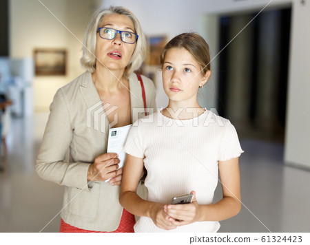 Woman and girl visiting museum Woman and girl visiting museum 61324423