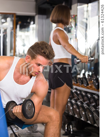 young athlete training biceps muscles. young athlete training biceps muscles. 61324426