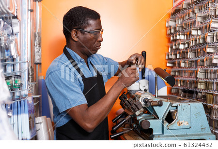 Locksmith working in workshop Locksmith working in workshop 61324432