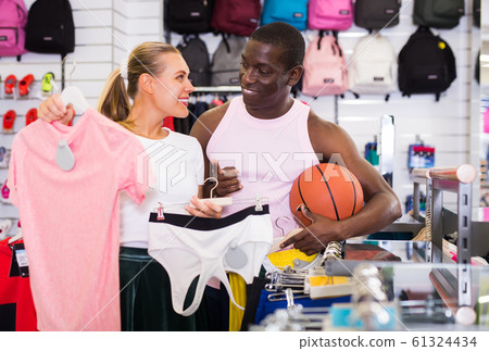 pair of customers choosing sport clothes pair of customers choosing sport clothes 61324434
