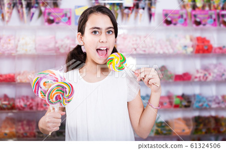 Emotional schoolgirl with lollipop Emotional schoolgirl with lollipop 61324506