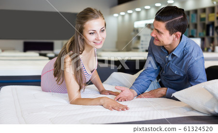 Young family choosing mattresses 61324520