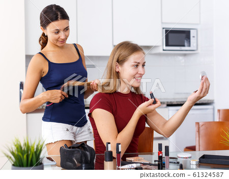 Women friends talking and applying make up Women friends talking and applying make up 61324587