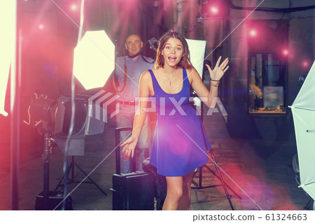 Young attractive woman delighted with professional photo shootin Young attractive woman delighted with professional photo shootin 61324663
