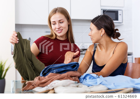 Girls talking and showing each other clothes 61324669