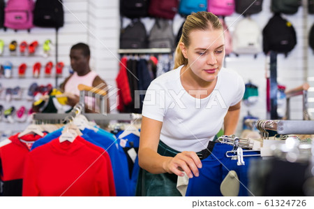 Girl buying sportswear Girl buying sportswear 61324726