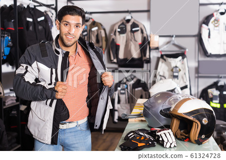 Active man is trying up new jacket for motorbike Active man is trying up new jacket for motorbike 61324728