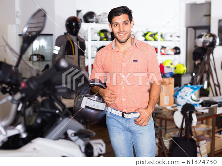 Portrait of male customer who is posing in new helmet Portrait of male customer who is posing in new helmet 61324730