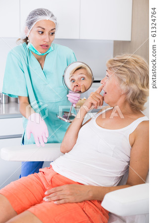 Unhappy woman in clinic of esthetic medicine Unhappy woman in clinic of esthetic medicine 61324764
