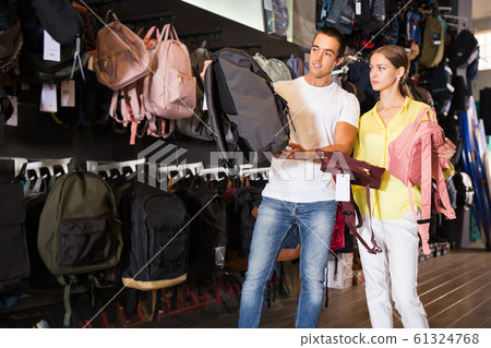 Couple choosing new backpack at store Couple choosing new backpack at store 61324768