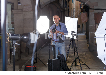 Professional fine photographer holding camera 61324781