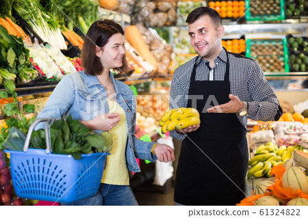Male seller assisting in buying 61324822