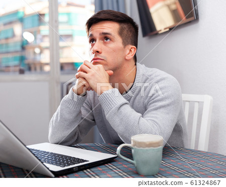 Tired man working with laptop at the home Tired man working with laptop at the home 61324867