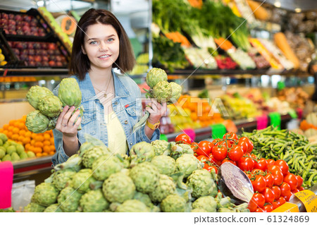 Woman choosing fruit Woman choosing fruit 61324869