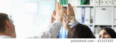Group business people hive five against office 61325285