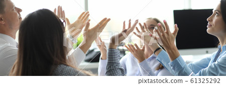 Team of business people raise hand from office background 61325292