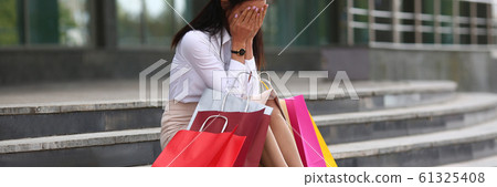 Wailful woman with shop bags near mall Wailful woman with shop bags near mall 61325408