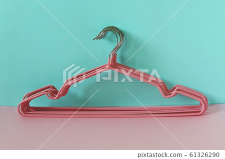 Clothes hangers on blue-pink background Clothes hangers on blue-pink background 61326290