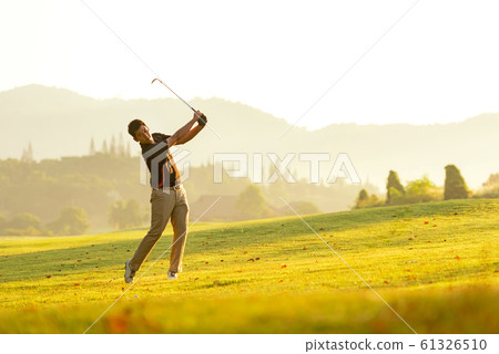 Professional Golfer asian man swing and hitting golf ball practice at golf driving range 61326510