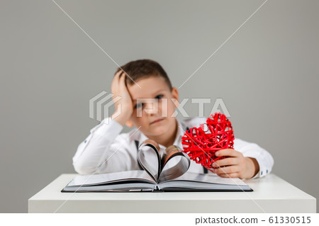 child boy with red heart and book 61330515