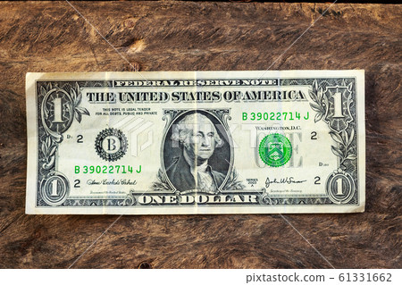 Old one dollar bill on grunge wood background 61331662