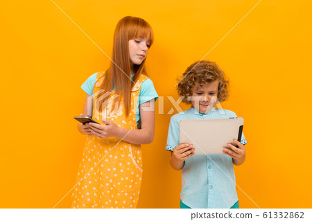 Beautiful girl with red hair has fun with her little brother Beautiful girl with red hair has fun with her little brother 61332862