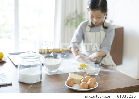 Girl baking cookies Girl baking cookies 61333239