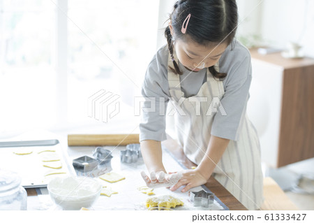 Girl baking cookies Girl baking cookies 61333427