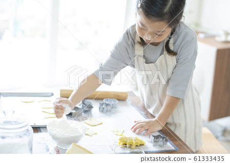 Girl baking cookies Girl baking cookies 61333435