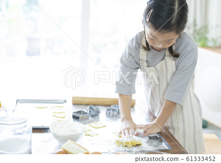 Girl baking cookies Girl baking cookies 61333452