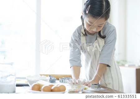 Girl baking cookies 61333551