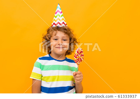 Little boy with curly hair in blue shirt and... - Stock Photo [61333937] -  PIXTA