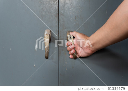Hand of men is opening old and rusty steel cabinet Hand of men is opening old and rusty steel cabinet 61334679