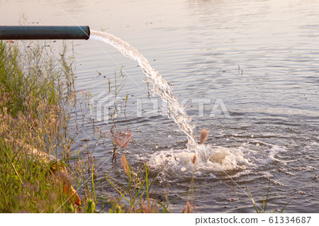 Pipe pump rush water falling in swamp 61334687