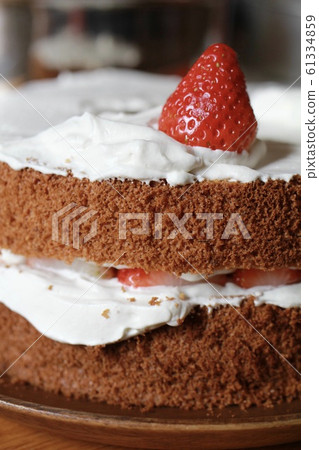 Strawberry chiffon cake in the middle of being decorated - handmade sweets 61334859