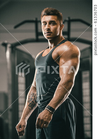 Handsome strong athletic men pumping up muscles 61336703