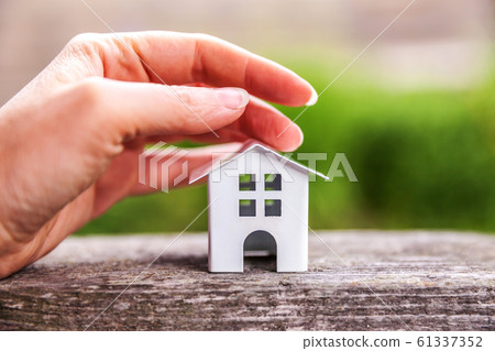 Miniature white toy model house and female woman 61337352