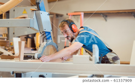 Diligent carpenter with fun at work Diligent carpenter with fun at work 61337909