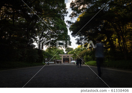 People walking through Meiji Jingu Shrine during the day People walking through Meiji Jingu Shrine during the day 61338406
