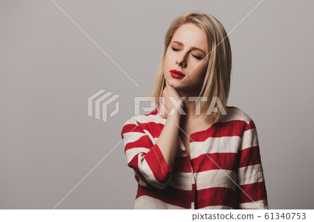 beautiful Surprised blonde woman in striped jacket beautiful Surprised blonde woman in striped jacket 61340753