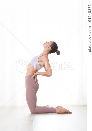 Portrait of gorgeous active sporty young woman practicing yoga in studio. Beautiful girl practice Ustrasana, camel yoga pose. Healthy active lifestyle, working out indoors in gym 61340875