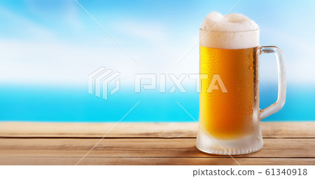 cold mug of beer on a wooden table on background cold mug of beer on a wooden table on background 61340918