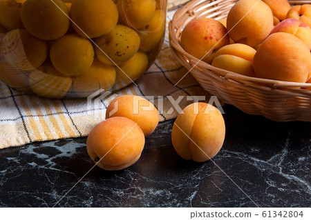 Fresh organic harvested apricots in basket and big Fresh organic harvested apricots in basket and big 61342804